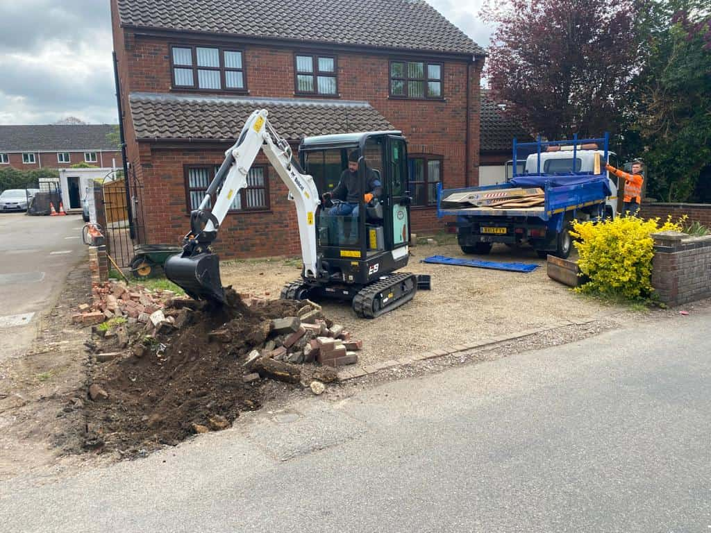 This is a photo of an operative of Bromham Driveways Digging out for a new tarmac driveway