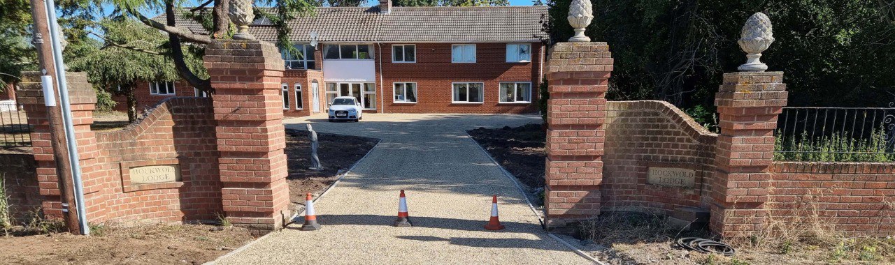 This is a photo of a newly installed chip and tar driveway, installed by Bromham Driveways